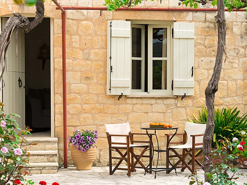 Arosmari Village Hotel | A cluster of stone and cypress wood cottages ...